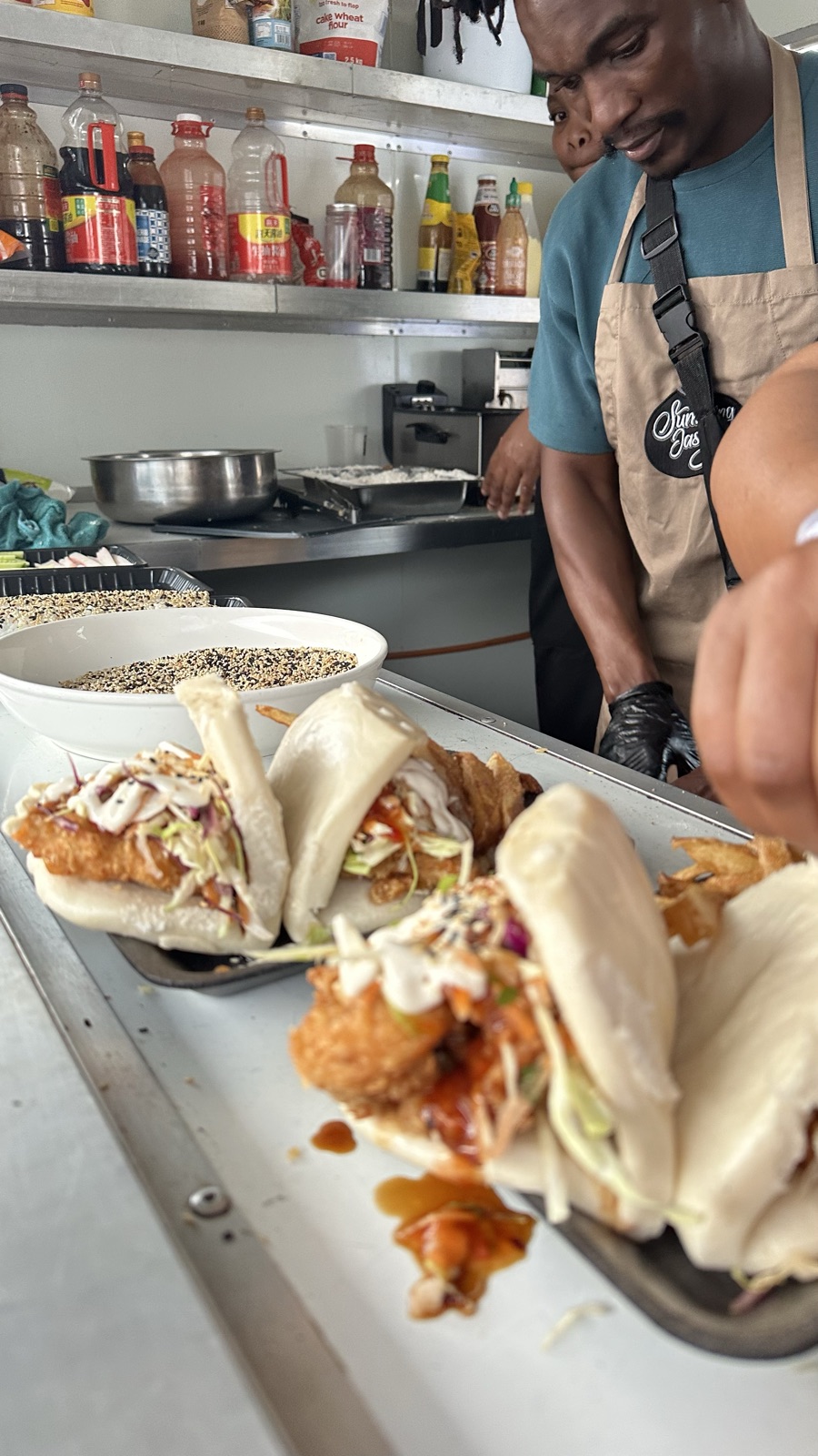 Chef plating bao buns in the SumthingTasty trailer